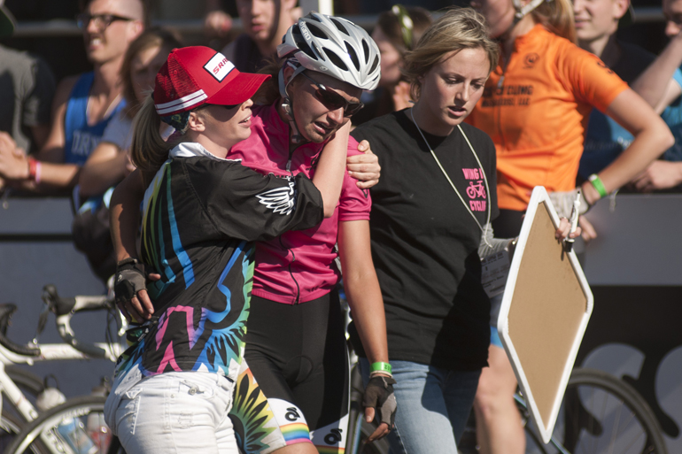 A Wing It rider is comforted after a rider exchange during the women\'s Little 500 at Bill Armstrong Stadium in Bloomington, Friday, April 25, 2014.