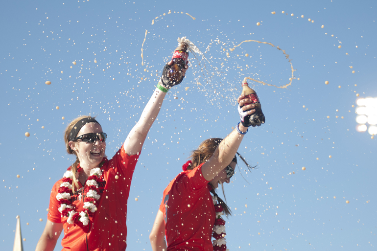 Brenna McGinn and Kate McDougal spray Coca-Cola into the crowd after winning the women\'s Little 500 at Bill Armstrong Stadium in Bloomington, Friday, April 25, 2014.
