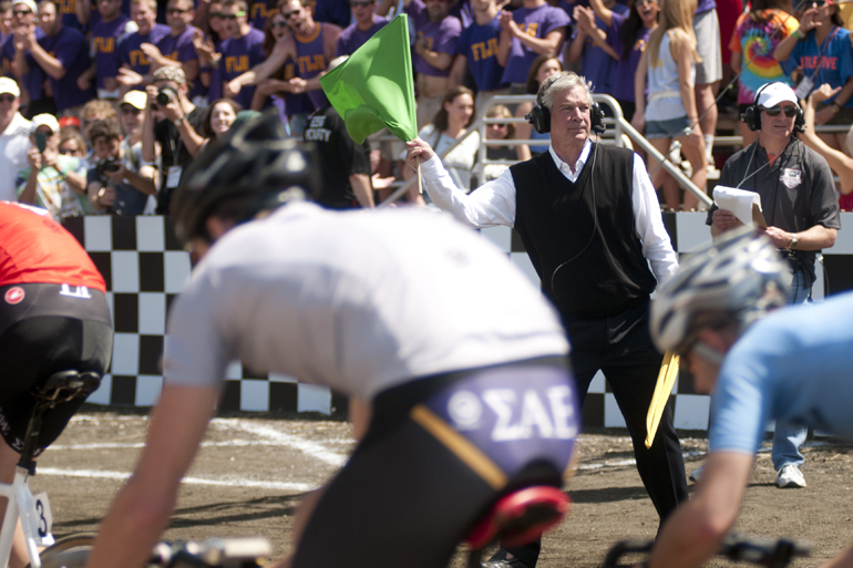 Chap Blackwell waves the green flag to start the men\'s Little 500 at Bill Armstrong Stadium in Bloomington, Saturday, April 26, 2014.