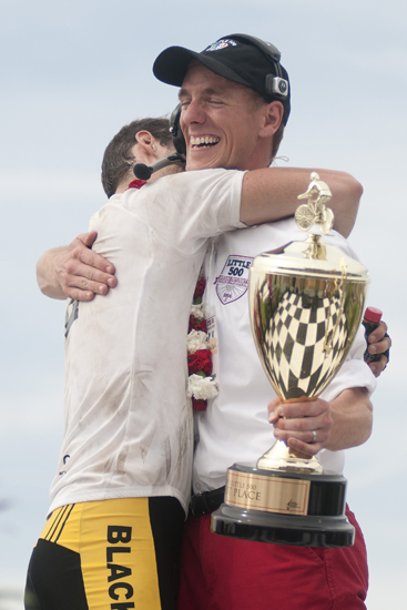 Race director Jordan Bailey gets a hug before handing the winner\'s trophy to Black Key Bulls after the men\'s Little 500 at Bill Armstrong Stadium in Bloomington, Saturday, April 26, 2014.