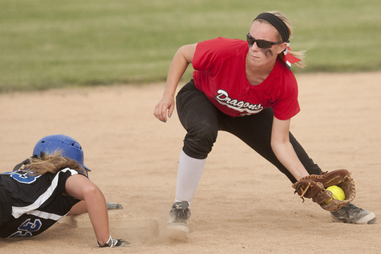 Franklin runner Shelby Taylor makes her way back to second base before the tag by New Palestine shortstop Adie Lorsung during the Sectional 13 softball championship game at Franklin Community High School, Wednesday, May 28, 2014.