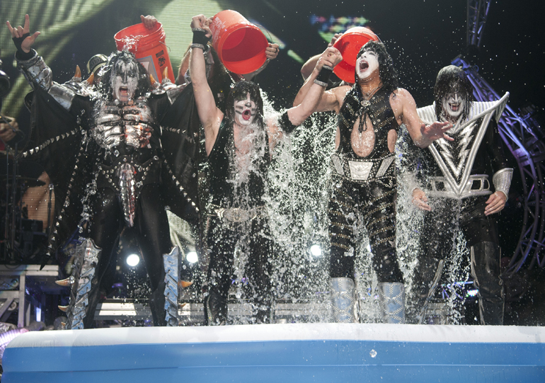 Members of KISS are drenched in ice water after accepting the ALS ice bucket challenge from Motley Crue at Klipsch Music Center, Friday, Aug. 22, 2014. KISS and Def Leppard each pledged $10,000 to the ALS Association and challenged music acts such as Elton John, U2 and Prince.