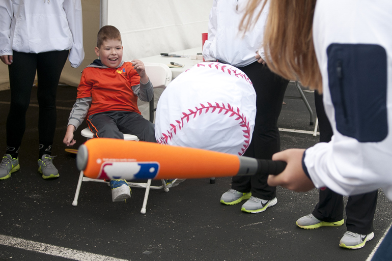 Braden Tamosaitis, 9, pitches an oversize softball to Notre Dame outfielder Megan Sorlie during the Riley Hospital for Children Neonatal Intensive Care Unit Reunion at Fairbanks Hall, Saturday, Sept. 13, 2014. Members of the Purdue and Notre Dame softball teams visited Riley to staff booths at the reunion and visit children at the Riley Hospital for Children Cancer Center.
