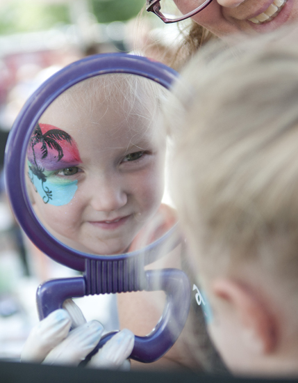 Valerie Flynn, 3, looks in the mirror at her new face paint during Fishers Oktoberfest at Saxony, Saturday, Sept. 28, 2013.