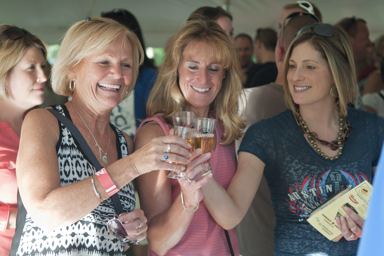 Deb Peterson, Lisa Zedonis and Jenny Weaver toast before sampling Redd\'s cider during the Noblesville Brewfest in Forest Park, Saturday, Sept. 28, 2013.