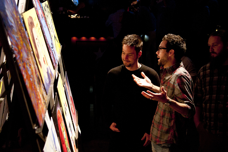 Ray Wagner and Ryan Alvis debate the worth of various paintings during the Art vs. Art competition at The Vogue in Broad Ripple, Friday, Sept. 27, 2013.