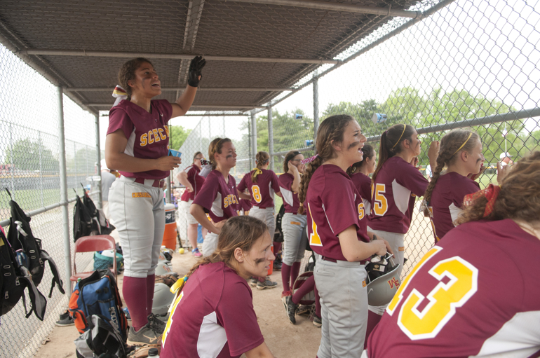 The Scecina dugout cheers during Scecina\'s 7-4 victory over Cathedral in the high school city softball title game at Brookside Park, Saturday, May 9, 2015.