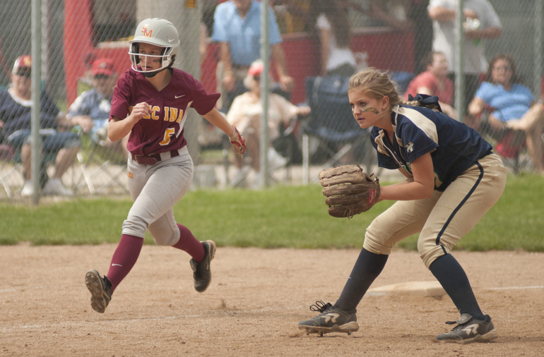 Scecina junior Lauren Ryan leads off of third base, defended by Cathedral senior Reagan Dalton, during Scecina\'s 7-4 victory over Cathedral in the high school city softball title game at Brookside Park, Saturday, May 9, 2015.