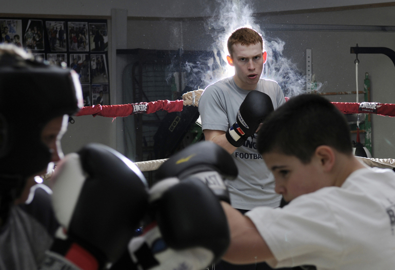 Lafayette Boxing Club\'s Tate Sturgeon watches as Kate Mane and Kyle Siple trade light jabs during a workout Tuesday, March 5, 2013, at the club building in Lafayette, Ind. Sturgeon and Mane, along with Luis Pena, Conan Hutchison and other boxers, competed at the Indiana Golden Gloves tournament on March 23 in Indianapolis.