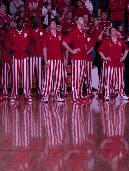 Indiana University players watch the pre-game highlight reel as their traditional pinstripes reflect off the hardwood floor before a game against the University of North Florida on Saturday, Dec. 7, 2013, at Assembly Hall in Bloomington, Ind. IU won the game, 89-68.
