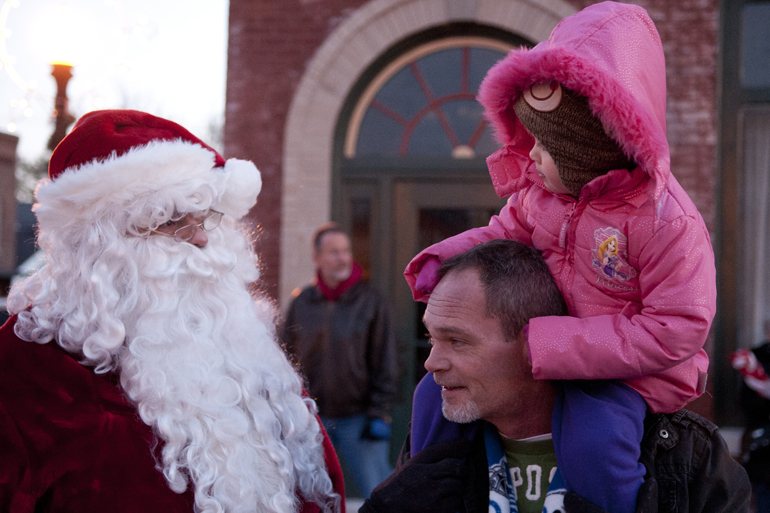 Santa Claus talks with Jada Crouch and her grandfather Wayne Crouch during Christmas on the Square in Danville, Friday, Nov. 29, 2013.