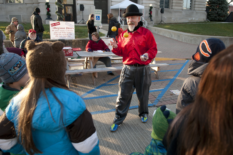Krembo K. from the Blue Monkey Sideshow juggles for kids during Christmas on the Square in Danville, Friday, Nov. 29, 2013.