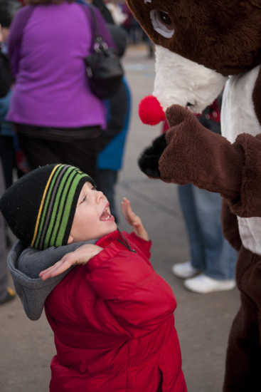 Wyatt Tennery gives a high-five to Rudolph the Red-Nosed Reindeer during Christmas on the Square in Danville, Friday, Nov. 29, 2013.