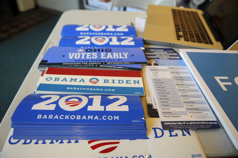 Bumper stickers sit on a table in a field office on Election Day.
