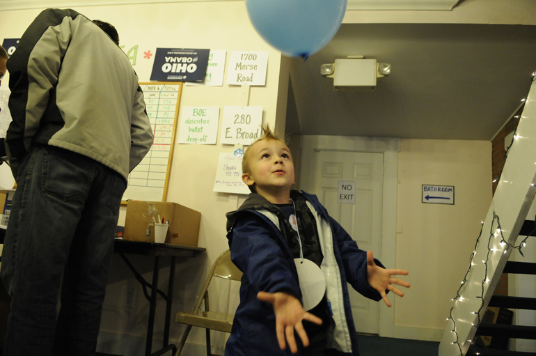 Collin Sauer plays with a balloon before going with his parents on a get-out-the-vote canvas.