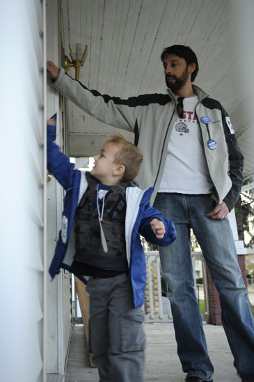 Collin Sauer and his father, Steven, knock on a door in a get-out-the-vote effort on Election Day.