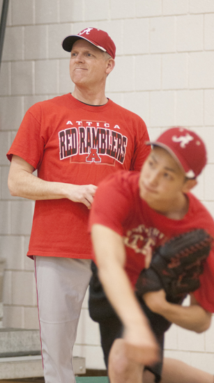 Attica (Ind.) High School baseball coach Rich Stoll watches sophomore Liam Dobbels pitch during practice on Thursday, April 11, 2013, in Lambert Memorial Gymnasium. Stoll, from Attica, pitched for the University of Michigan and was a first-round draft pick for the Montreal Expos.