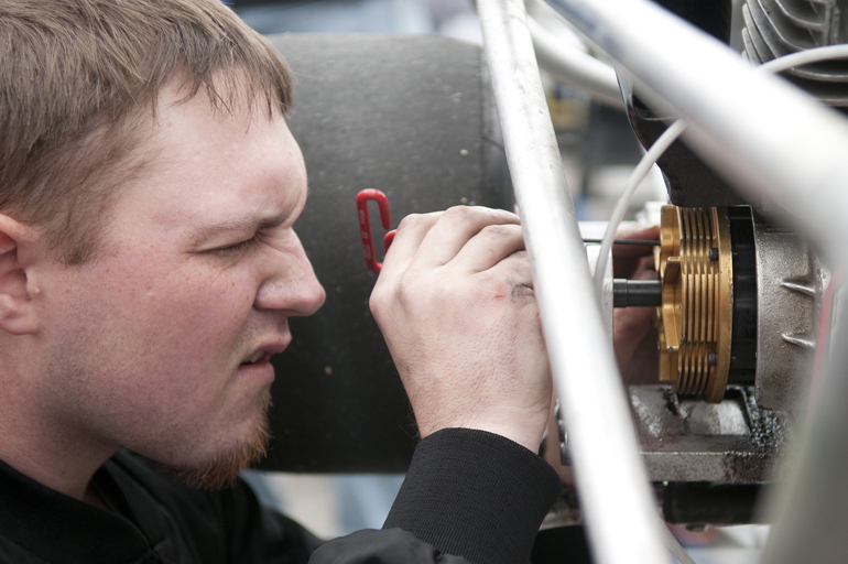 Alpha Gamma Rho fraternity driver Zach Miller works on the clutch of his Yamaha motor during practice for the Purdue Grand Prix on Friday, April 12, 2013, at the Grand Prix track.