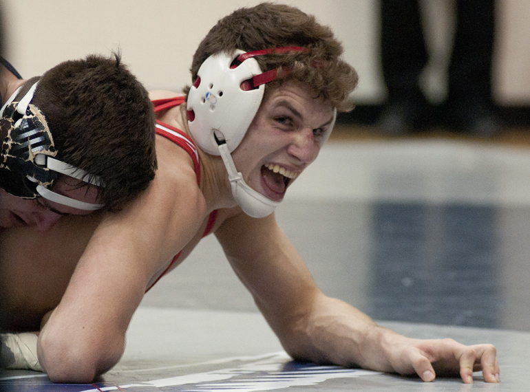 Jared Timberman of New Palestine attempts to escape from Brandon James of Perry Meridian in the 138 lbs. championship match during a high school wrestling regional meet at Perry Meridian High School, Saturday, Feb. 7, 2015.
