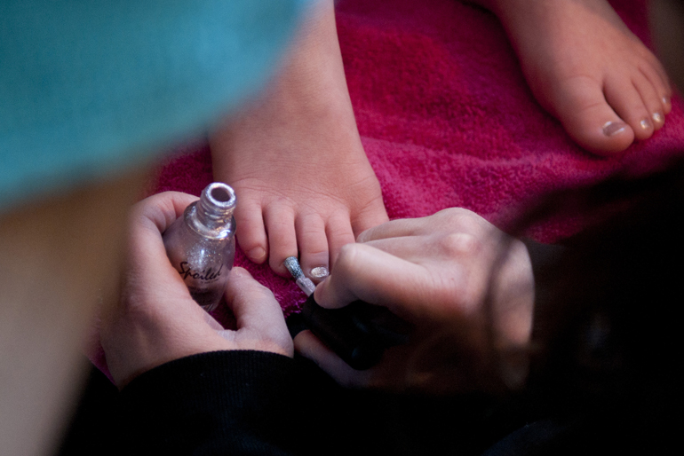 Jessica Johnson, co-owner of Pretty and Posh Parties, paints the nails of Kate Hollingsworth, 7, during Hollingsworth\'s birthday party and spa treatment provided by Pretty and Posh Parties at her home in Fishers, Sunday, Feb. 15, 2015.