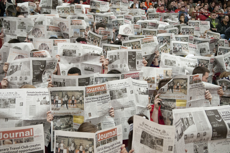 Southport students hold newspapers in front of their faces as Evansville Reitz players are introduced before the Southport boys\' basketball team\'s 88-80 victory over Evansville Reitz at Southport High School, Saturday, Feb. 28, 2015.