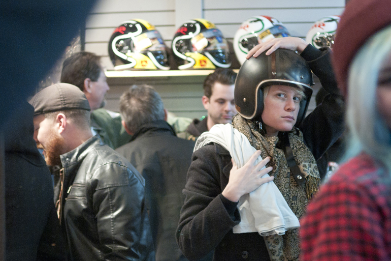 Marcella Snyder looks in the mirror as she tries on a helmet designed by National Moto+Cycle Co. at Motorcycle Apparel and Accessories\' silent auction benefiting FACE Low-Cost Spay/Neuter Clinic, Friday, Feb. 7, 2014.