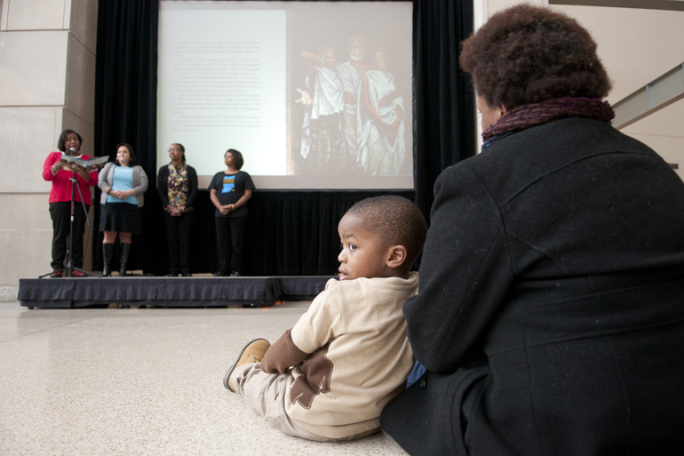 Garrison Brown, 2, and Jinai Lewis listen to a reading of the short story \