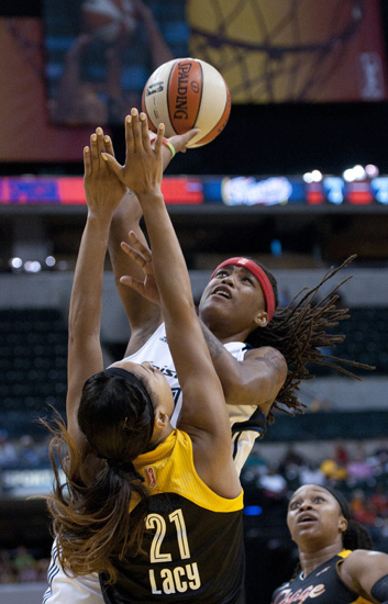 Fever guard Shavonte Zellous shoots over Shock forward Jennifer Lacy during the Indiana Fever\'s 107-102 overtime loss to the Tulsa Shock at Bankers Life Fieldhouse, Wednesday, June 25, 2014.