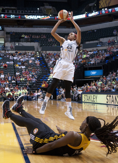 Fever guard Marissa Coleman shoots as Shock guard Roneeka Hodges falls to the floor during the Indiana Fever\'s 107-102 overtime loss to the Tulsa Shock at Bankers Life Fieldhouse, Wednesday, June 25, 2014.