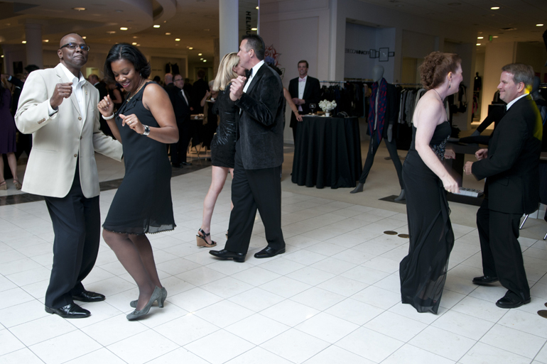 Attendees dance to music played by The Flying Toasters during the Key to the Cure Gala at Saks Fifth Avenue in Indianapolis, Friday, Oct. 11, 2013.