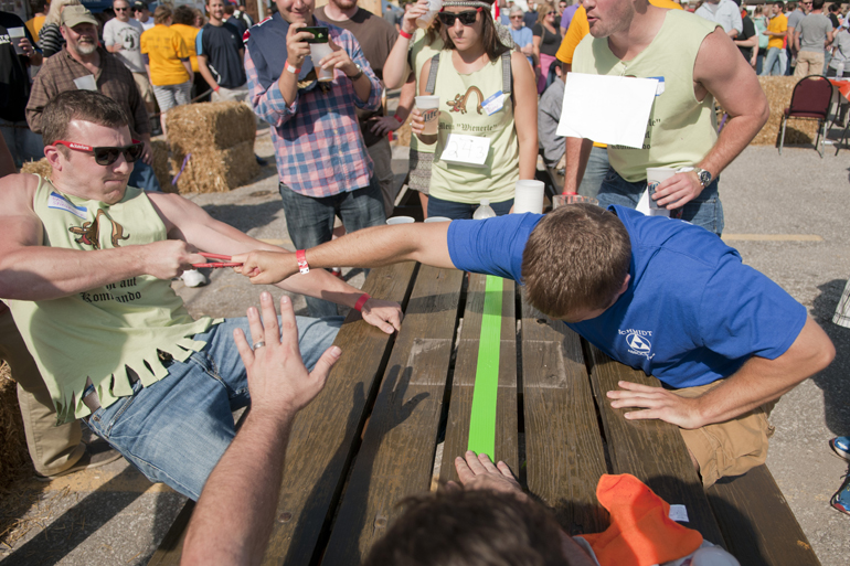 Brandon Barkley beats Adam Palmer in Fingerhakeln during GermanFest\'s Beer Games at the Athenaeum in Indianapolis, Saturday, Oct. 12, 2013.