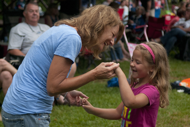 Kathy Pitcock and her granddaughter, Mikayla Pitcock, 6, dance together during a Greenwood Summer Concert Series event at the Greenwood Amphitheater, Saturday, July 20, 2013.