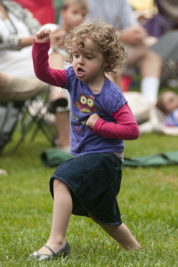 Lilly Hufford, 3, dances during a Greenwood Summer Concert Series event at the Greenwood Amphitheater, Saturday, July 20, 2013.