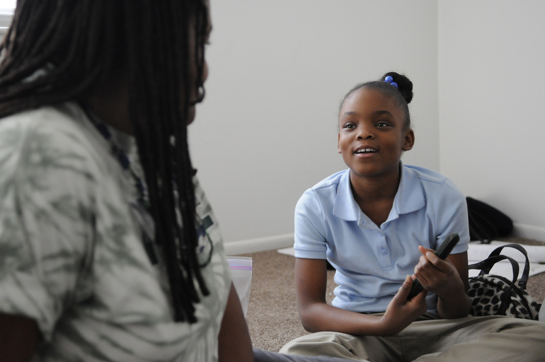 Peace Education Facilitator Naeemah Jackson listens as Jazmine Heffner, 10, introduces herself during a Peace Learning Center group session.