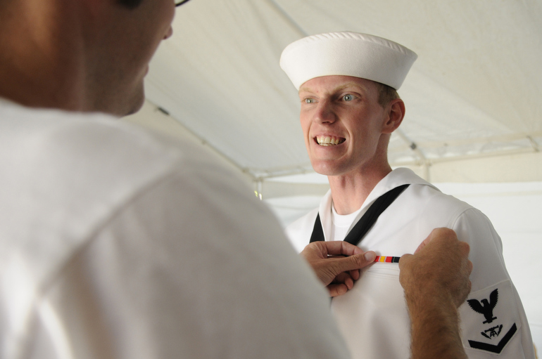 Patrick makes a face as his brother (and the ceremony's celebrant) Nick puts a pin on his U.S. Navy uniform.