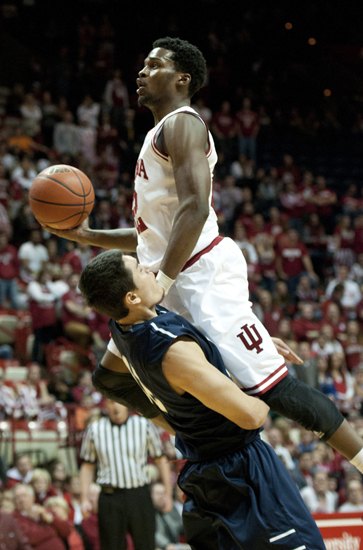 Hoosier guard Stanford Robinson drives for a rebound over North Florida guard Aaron Bodager during IU\'s 89-68 victory against the University of North Florida at Assembly Hall in Bloomington, Saturday, Dec. 7, 2013.