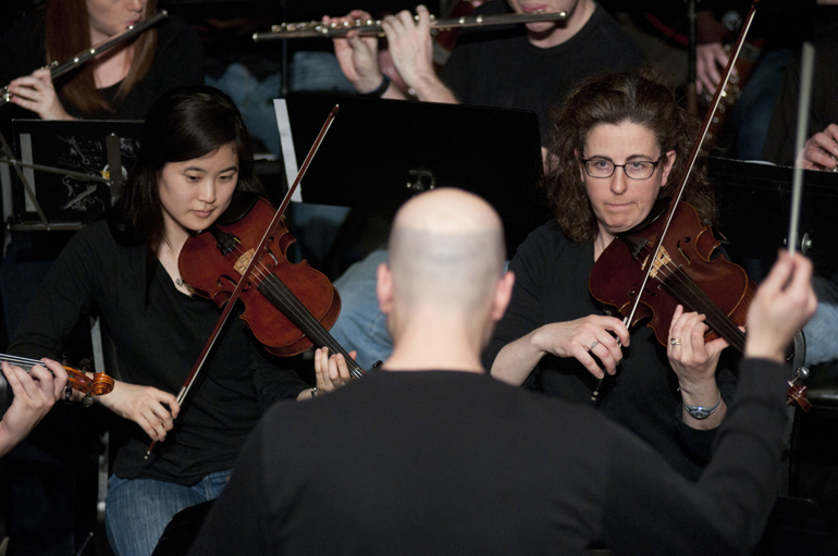 Members of the IU School of Medicine orchestra, led by David P. Schurger (foreground), perform music from \