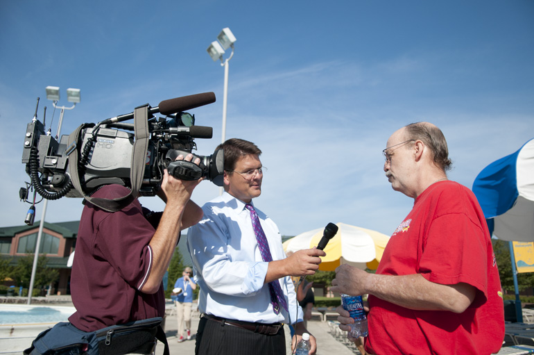 Mark Alderson talks with WISH-TV's Scott Sander after thanking Splash Island's Shelby Partin and other lifeguards for saving his life in June, in Plainfield, Friday, Aug. 3, 2012.