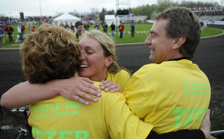 Teter senior Caitlin Van Kooten hugs her parents, Mary and Rick, after winning the women’s Little 500 on Friday at Bill Armstrong Stadium. Van Kooten’s team won the race for the second year in a row by lapping the field.