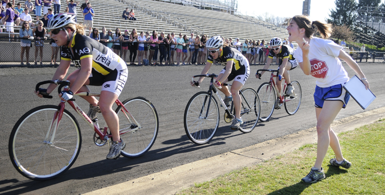 Graduate student and former Kappa Alpha Theta rider Kristen Metherd yells times at her team during Little 500 Team Pursuit on Saturday at Bill Armstrong Stadium.