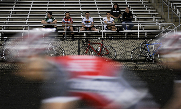 Riders from the Cutters watch Delta Tau Delta race down the front straightaway during the Little 500 Team Pursuit final. The Cutters missed the final heat by a recorded tenth of a second.