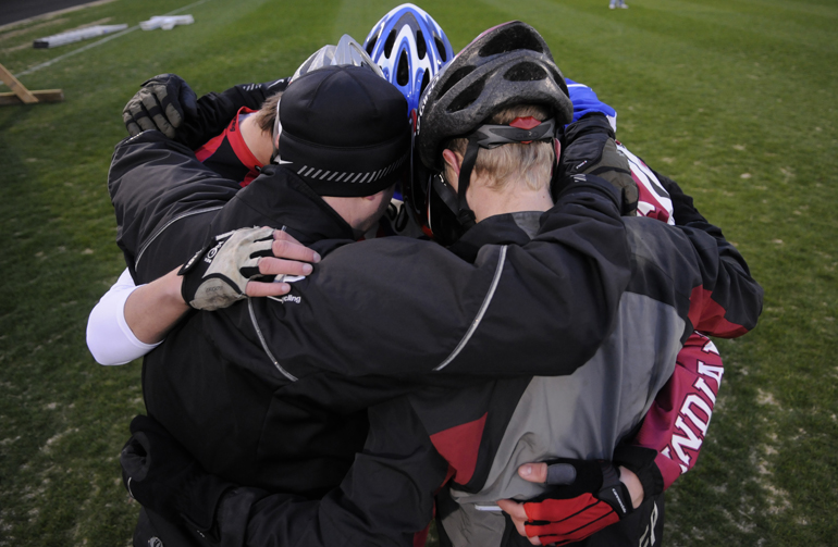 Members and coaches for the Sigma Phi Epsilon team huddle before their 8 a.m. run in the first session of Little 500 qualifications Saturday at Bill Armstrong Stadium.