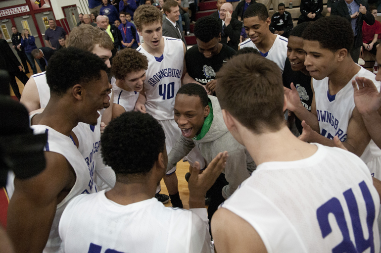 Brownsburg High School players huddle before the Richmond boys\' basketball team\'s 71-65 victory over Brownsburg for the Southport Regional title at Southport High School, Saturday, March 14, 2015.