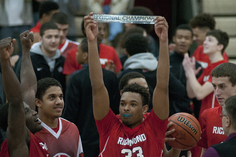Richmond senior forward Auntonio Brown raises the regional champion plate after his team\'s 71-65 victory over Brownsburg for the Southport Regional title at Southport High School, Saturday, March 14, 2015.