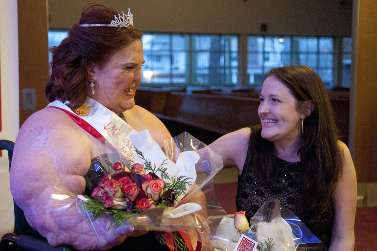Ruth Smith receives congratulations from Angela Knartzer, wife of judge Kevin Knartzer, for being crowned Ms. Wheelchair Indiana at the Basile Opera Center, Saturday, March 29, 2014.