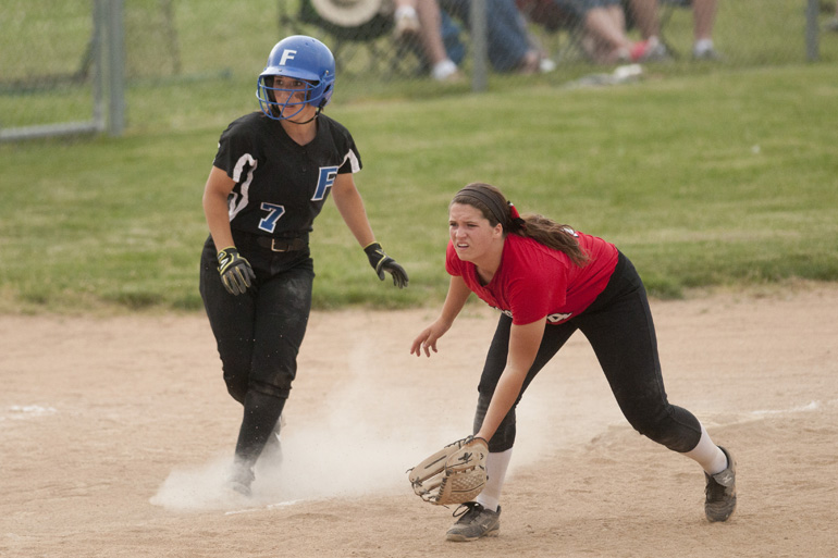 Franklin outfielder/catcher Krystal Scott leads off of third base as New Palestine infielder Issy Hoyt prepares for a base hit during the Sectional 13 softball championship game at Franklin Community High School, Wednesday, May 28, 2014.