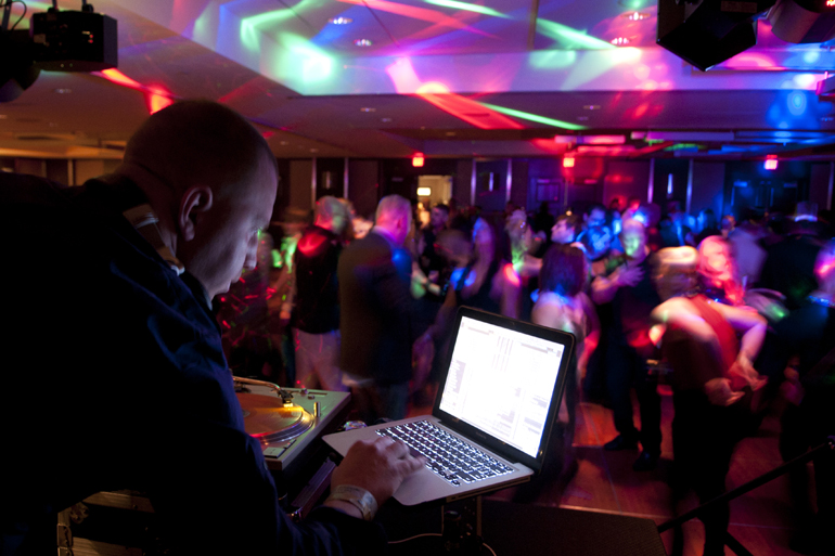 DJ Helicon picks music to mix during the New Year\'s Eve Rock \'n\' Roll Ball at the Hyatt Regency downtown, Tuesday, Dec. 31, 2013.