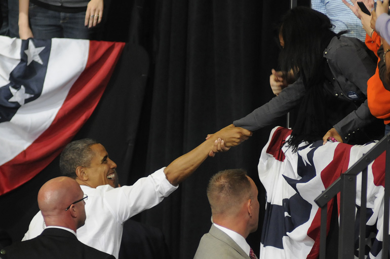 U.S. President Barack Obama shakes hands with a supporter during a presidential campaign stop Sept. 26 at Bowling Green State University's Stroh Center in Bowling Green, Ohio. Former Mass. Governor Mitt Romney also campaigned in Ohio on Sept. 26, at the Sea Gate Convention Center in Toledo, Ohio.