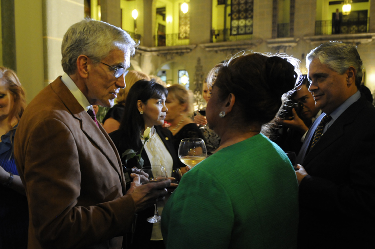 Dr. Merrill Ritter talks with Rosa Leal de Pérez, Guatemala\'s first lady, after the changing of the rose ceremony Tuesday, Feb. 26, 2013, at the National Palace. The ceremony, held every month, has its origins in the acts that ended the country\'s 36-year civil war in 1996. Those selected to participate, like Dr. Ritter, are designated Ambassadors for Peace in honor of the good they do for the people of Guatemala.