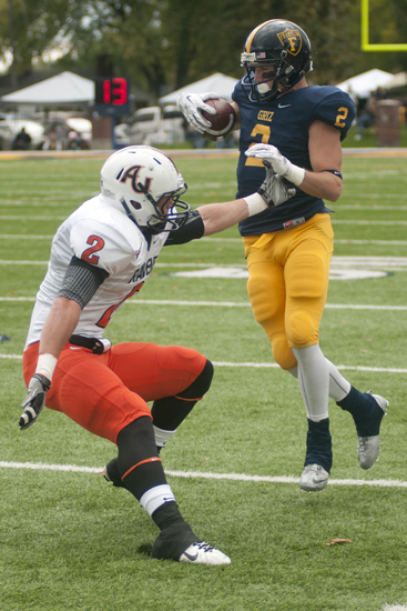 Wide receiver Kyle Linville evades a tackle from Tyler Ganus after a catch during Franklin College\'s football game against Anderson University in Franklin, Saturday, Oct. 19, 2013. Franklin\'s \